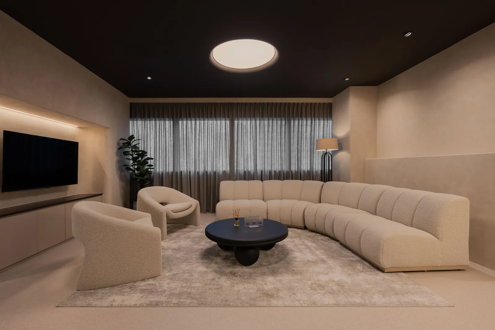 Rooms for Renewal: lounge with a long curved sofa, boucle armchairs and a round coffee table