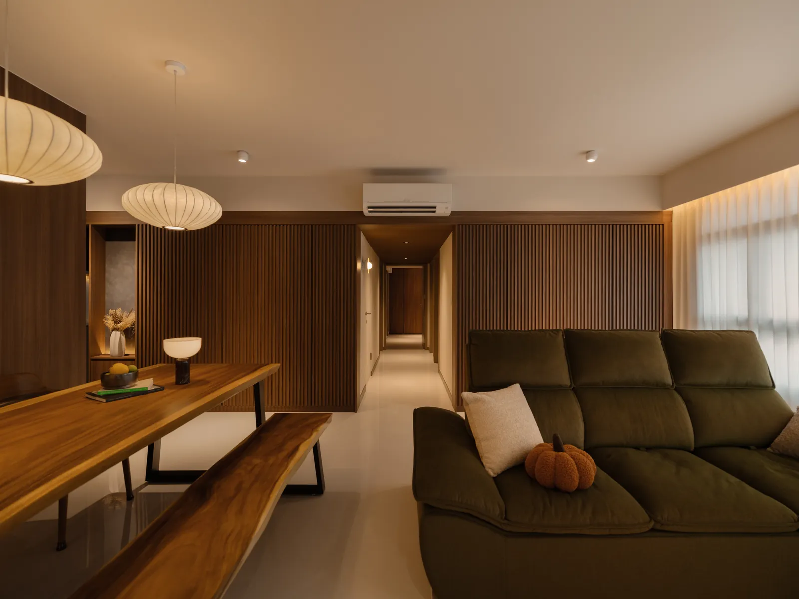 Mid Century Sanctuary: living and dining room with an olive sofa, a timber slab table and paper lanterns