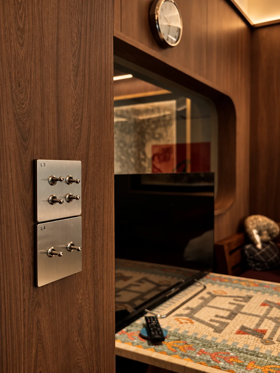 Library for the Arborist: brushed steel toggle switches on a timber wall beside a rounded opening