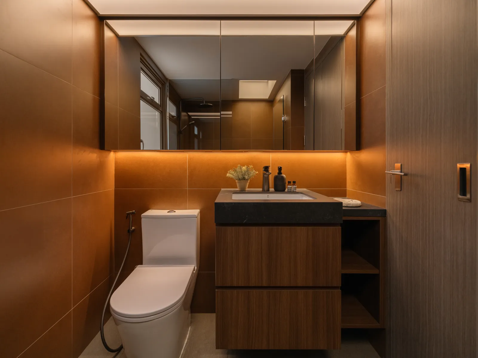 Mid Century Sanctuary: bathroom in warm brown tiles with a timber vanity and a backlit mirror cabinet