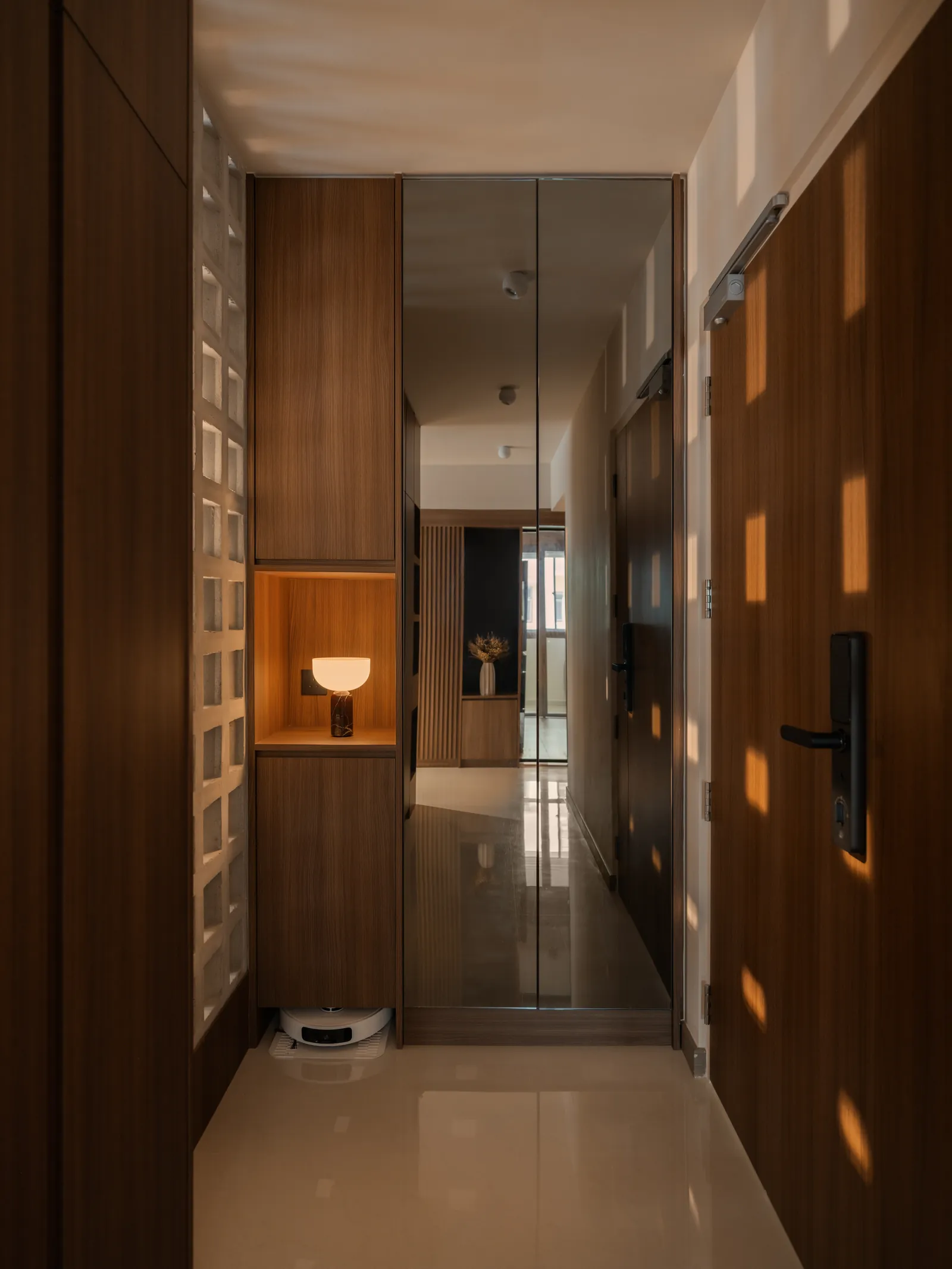 Mid Century Sanctuary: entrance passage in warm timber, with a glass block wall and a lit niche