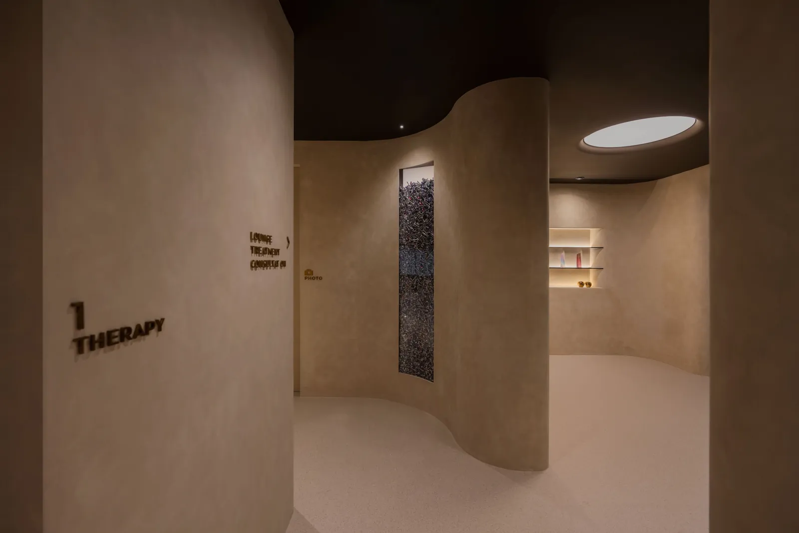 Rooms for Renewal: curved passage to the therapy rooms under a round ceiling light