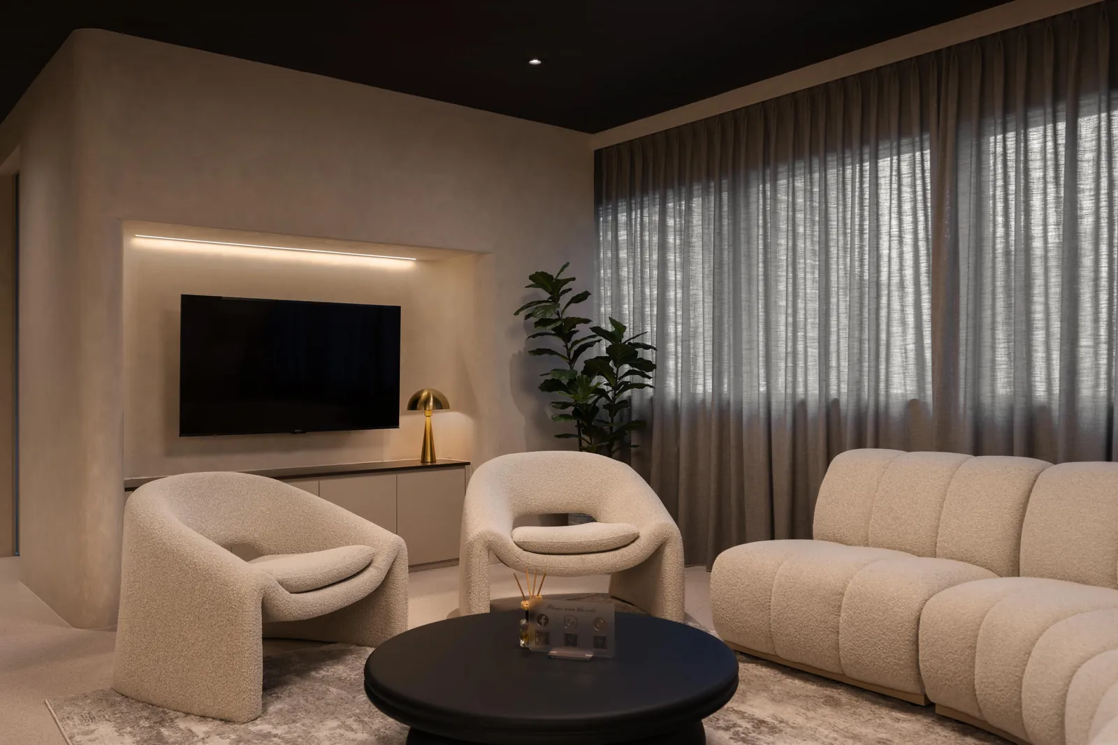 Rooms for Renewal: boucle armchairs and a sofa in the lounge, with sheer curtains behind