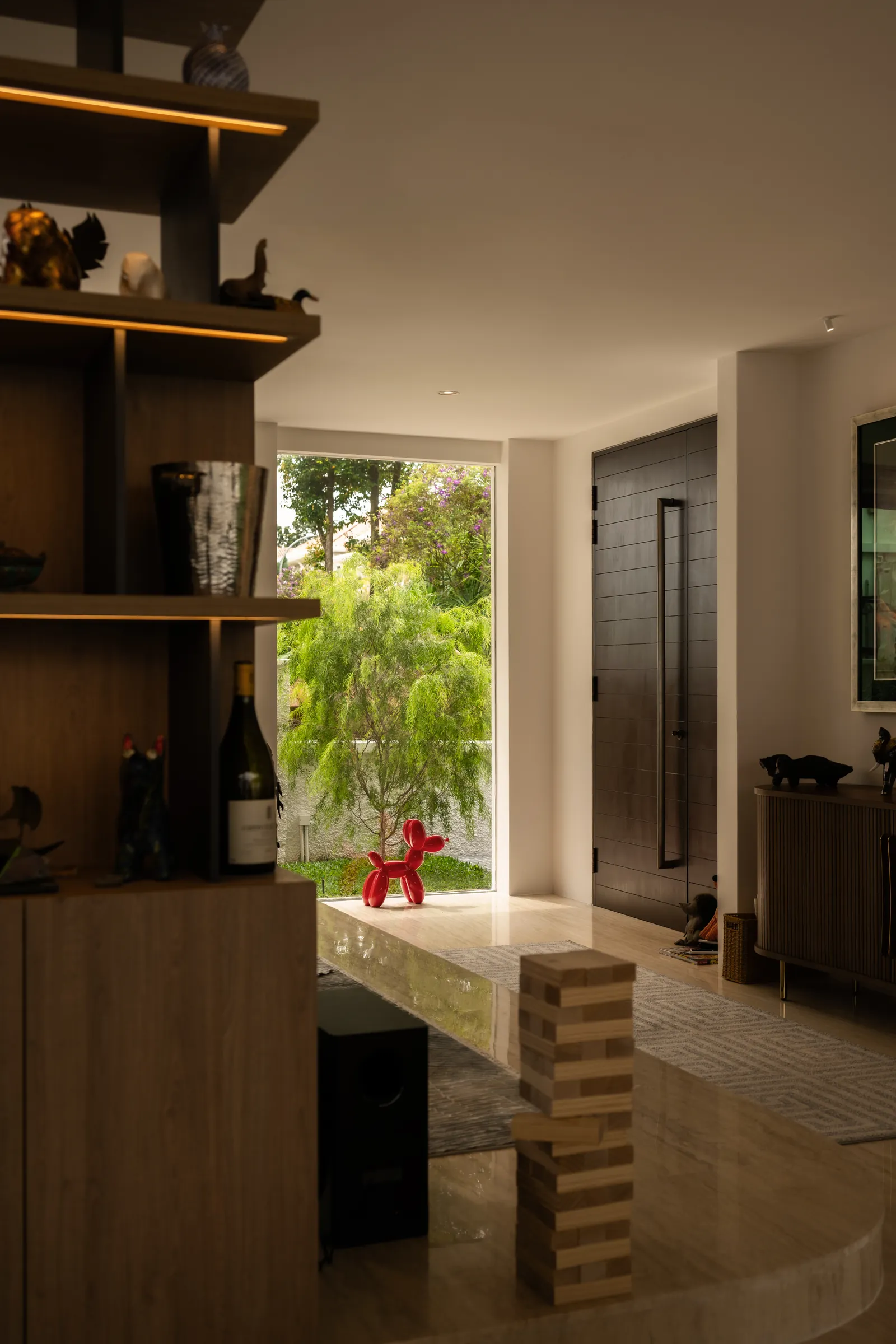 The Art of Retreat: bar shelving with wine and sculpture, looking out to the garden