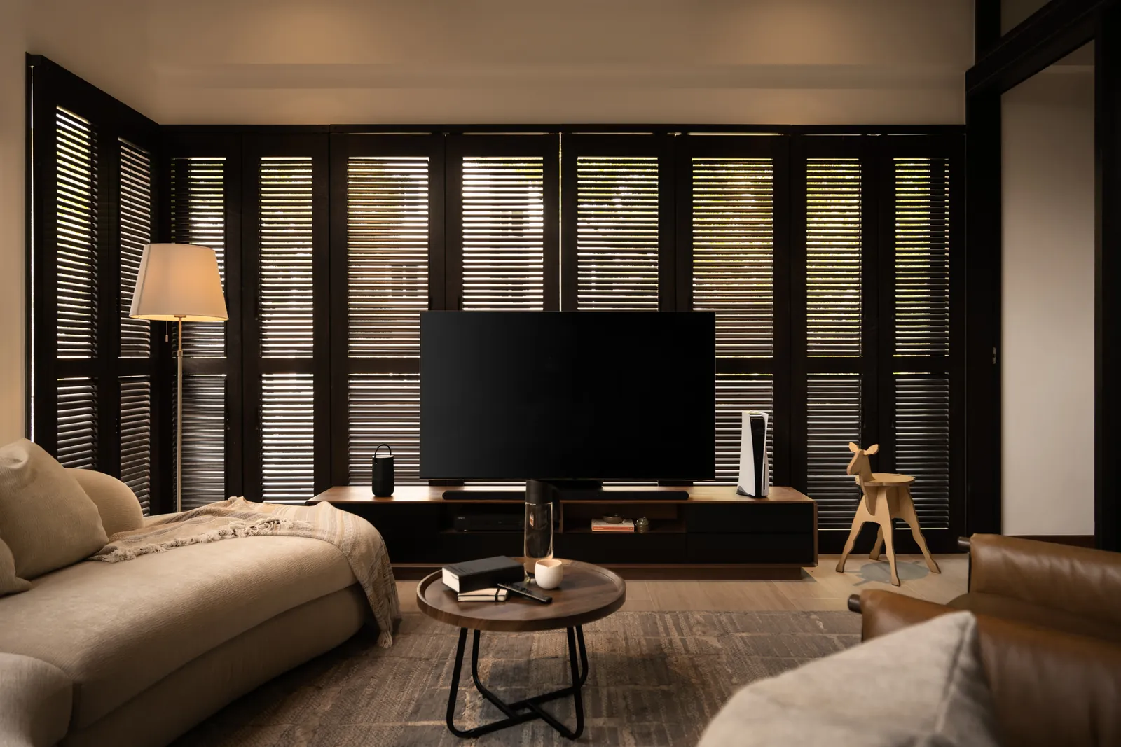 The Art of Retreat: upstairs family room lined with dark timber shutters